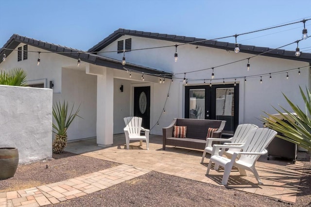 rear view of house featuring french doors and a patio