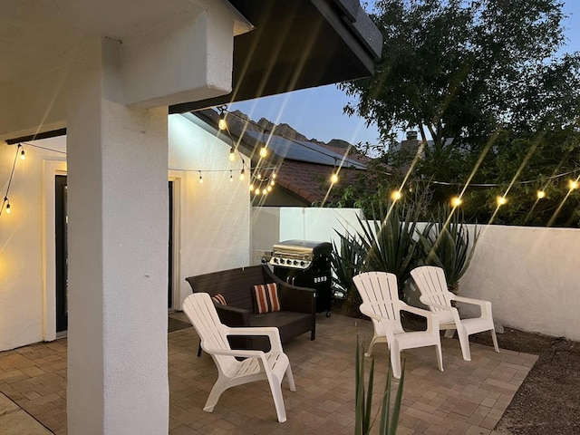 patio terrace at dusk with a grill