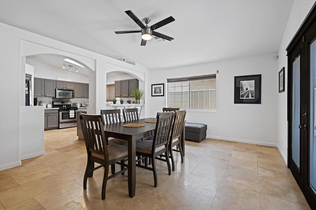 dining space featuring ceiling fan and vaulted ceiling