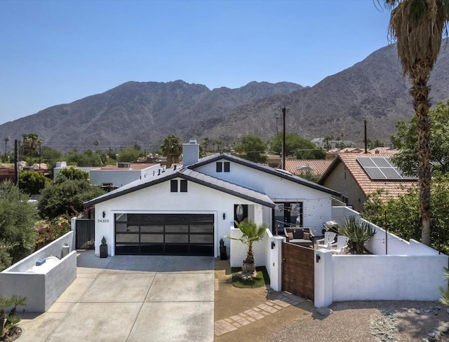 view of front of house featuring a garage and a mountain view