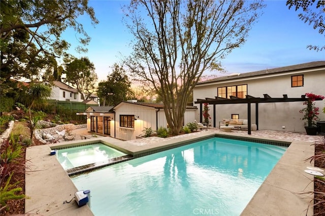 pool at dusk featuring a patio area, a pergola, and an in ground hot tub