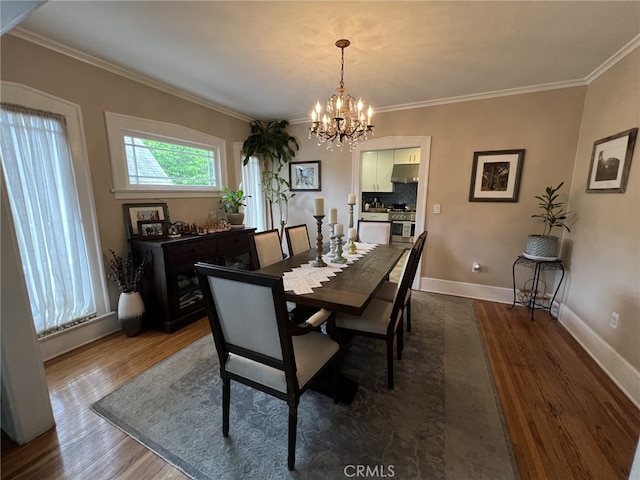 dining space with ornamental molding, dark wood-type flooring, and a chandelier