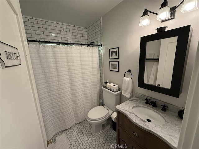 bathroom featuring tile patterned floors, walk in shower, vanity, and toilet