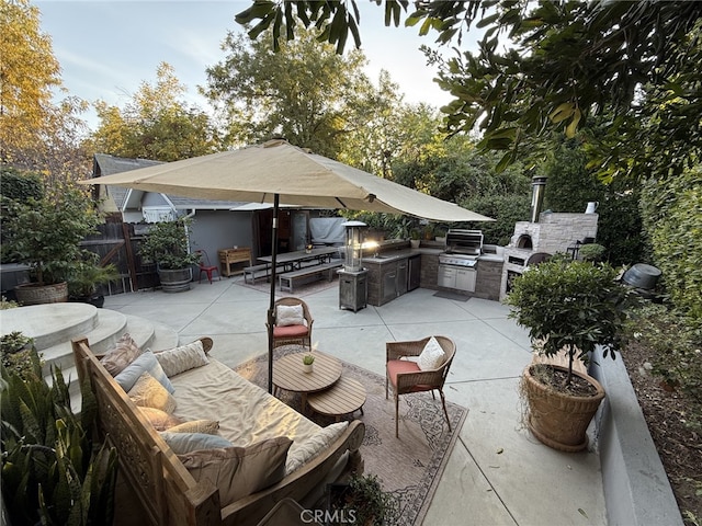 view of patio featuring an outdoor living space, area for grilling, and exterior kitchen