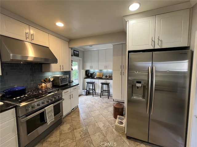 kitchen with decorative backsplash, white cabinetry, and stainless steel appliances