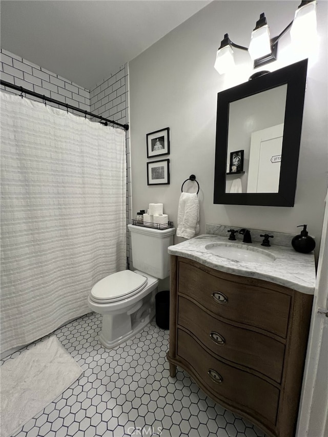 bathroom featuring tile patterned flooring, vanity, and toilet