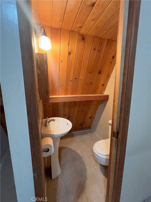 bathroom with sink, toilet, and wood ceiling