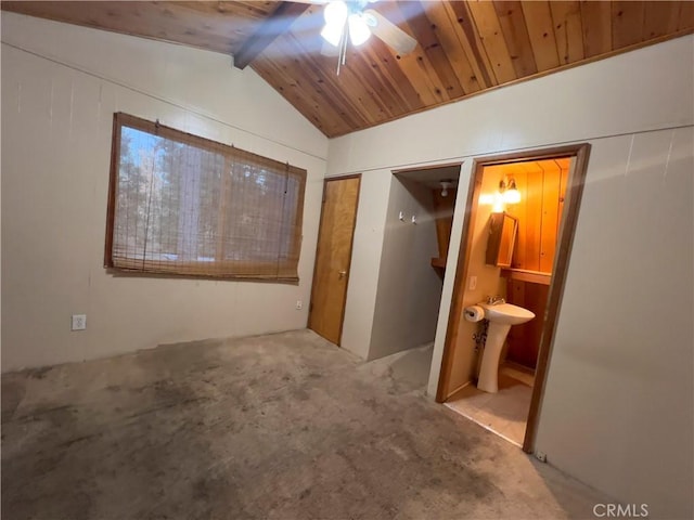 interior space with ceiling fan, sink, lofted ceiling with beams, carpet, and wood ceiling