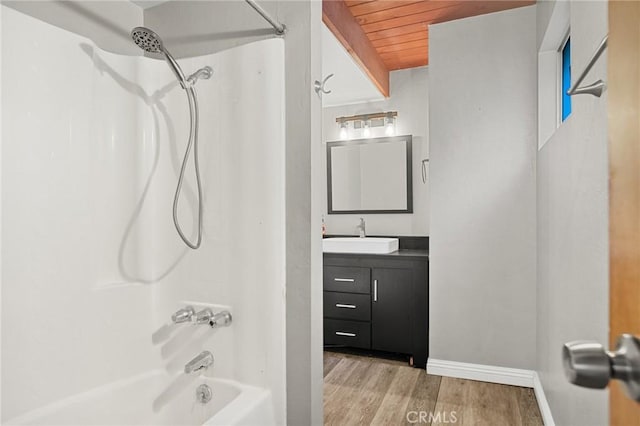 bathroom with vanity, baseboards, shower / bathing tub combination, wood ceiling, and wood finished floors