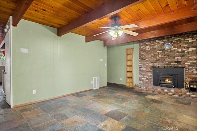 unfurnished living room with stone tile flooring, baseboards, wooden ceiling, and beam ceiling
