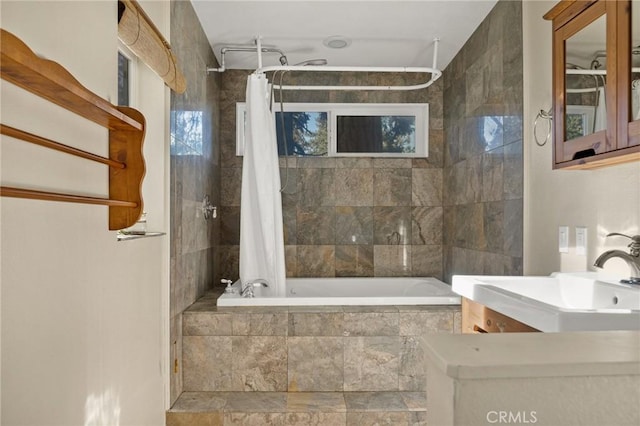 full bath featuring a sink and tiled shower / bath