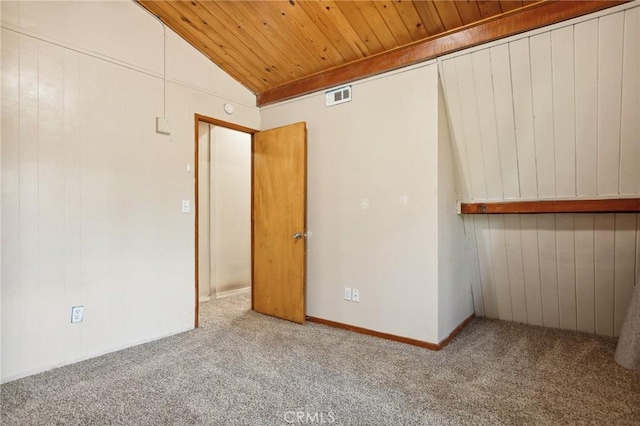 unfurnished bedroom featuring carpet, visible vents, wood ceiling, and vaulted ceiling