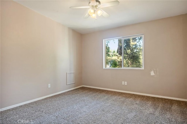 spare room featuring baseboards, a ceiling fan, and carpet flooring