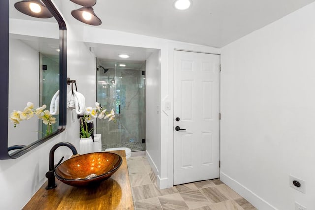 bathroom featuring sink and a shower with door