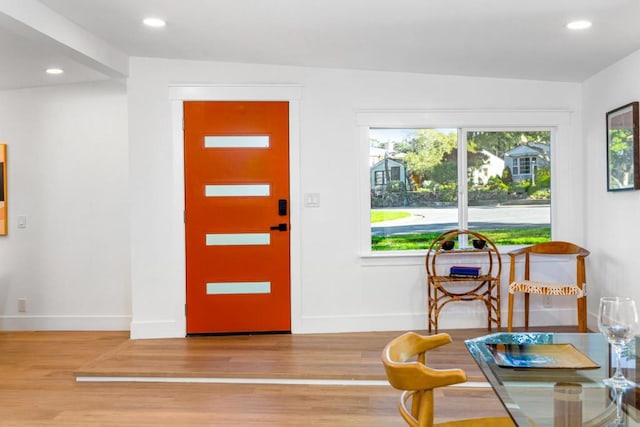 entryway featuring hardwood / wood-style floors and lofted ceiling