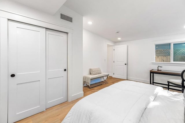 bedroom with a closet and light hardwood / wood-style flooring