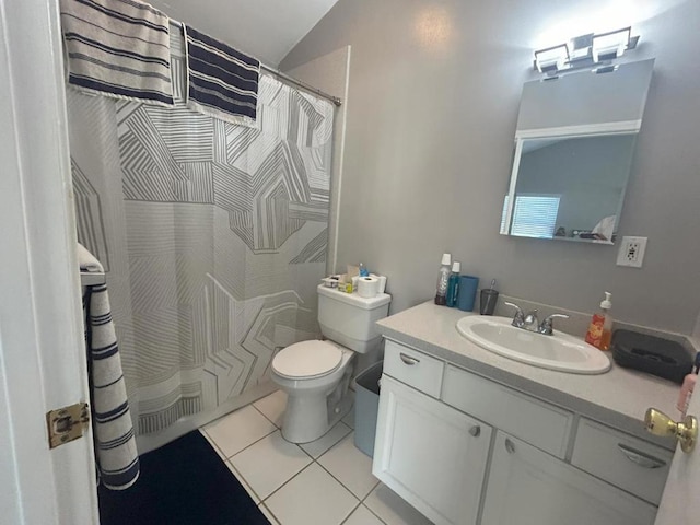 bathroom with tile patterned flooring, vanity, toilet, and vaulted ceiling