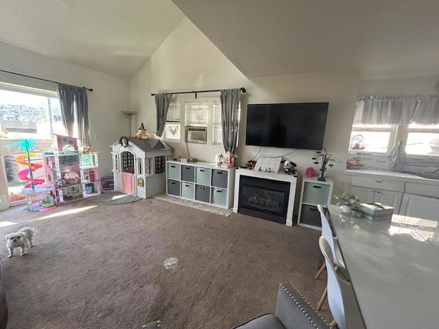 interior space with carpet floors and vaulted ceiling