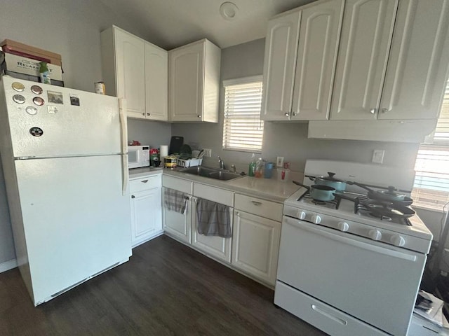 kitchen with white cabinets, dark hardwood / wood-style flooring, white appliances, and sink