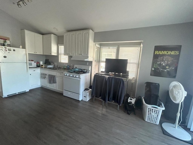 kitchen with white cabinetry, sink, dark wood-type flooring, and white appliances