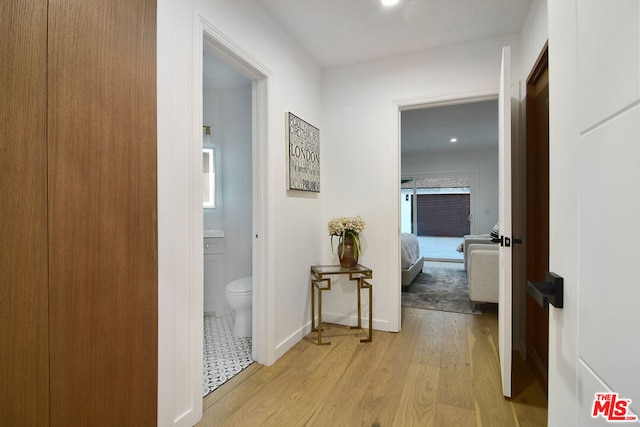 hallway with light hardwood / wood-style floors