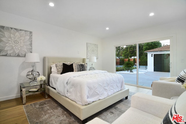 bedroom featuring access to exterior and dark hardwood / wood-style floors