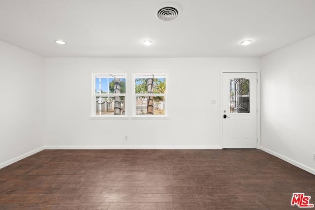 unfurnished room featuring dark hardwood / wood-style floors