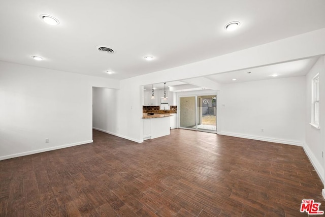 unfurnished living room featuring dark hardwood / wood-style flooring