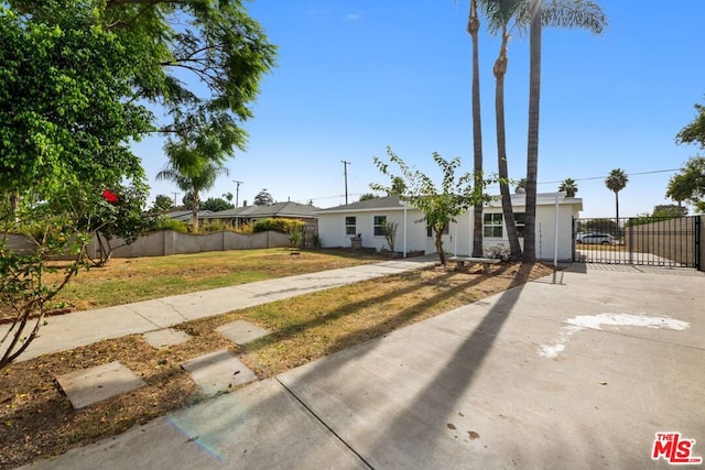 ranch-style home with a front lawn