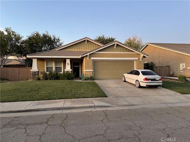 view of front of house with a garage and a front lawn