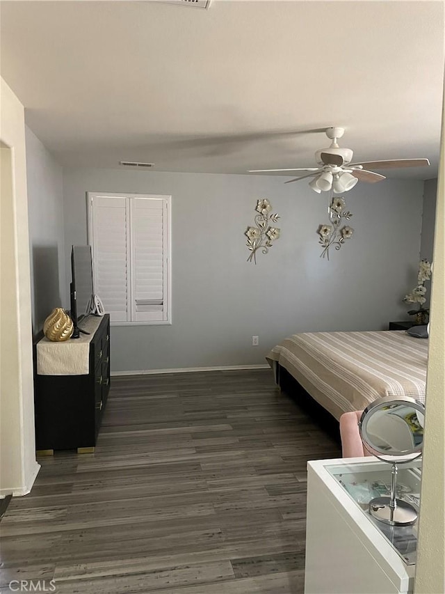 bedroom featuring ceiling fan and dark hardwood / wood-style flooring