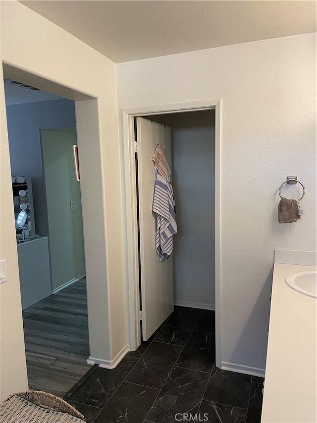 interior space with hardwood / wood-style floors and vanity