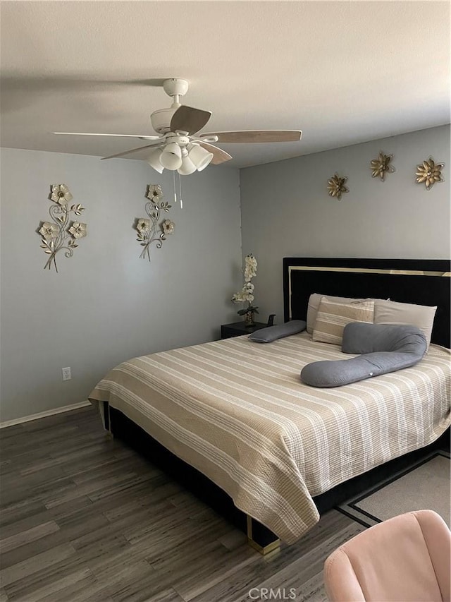 bedroom with dark hardwood / wood-style floors and ceiling fan