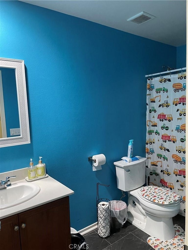 bathroom featuring curtained shower, vanity, and toilet