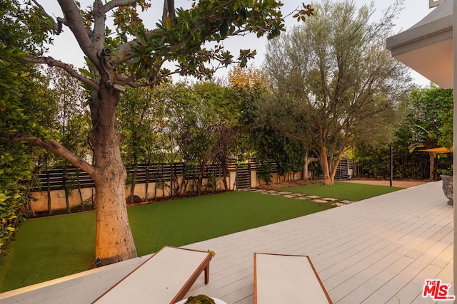 exterior space featuring a lawn and a deck