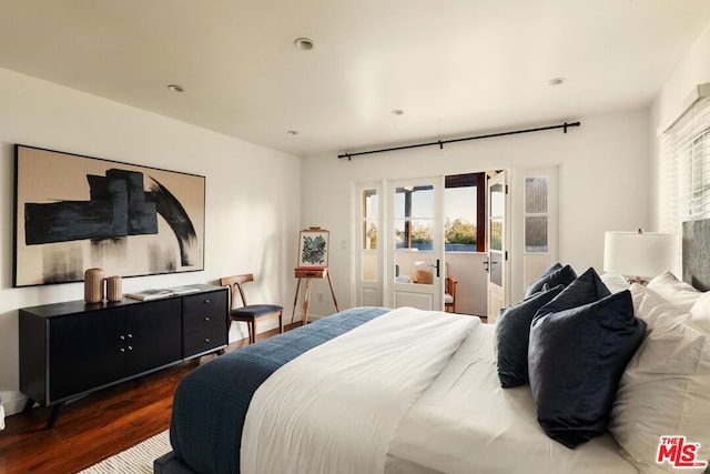 bedroom with dark wood-type flooring