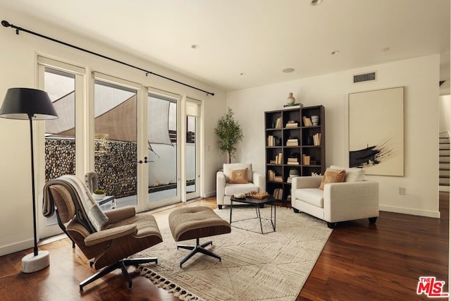 sitting room featuring hardwood / wood-style floors and french doors