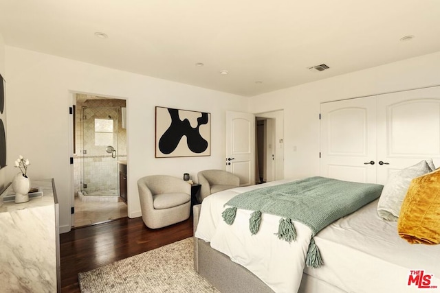 bedroom featuring ensuite bathroom, wood-type flooring, and a closet