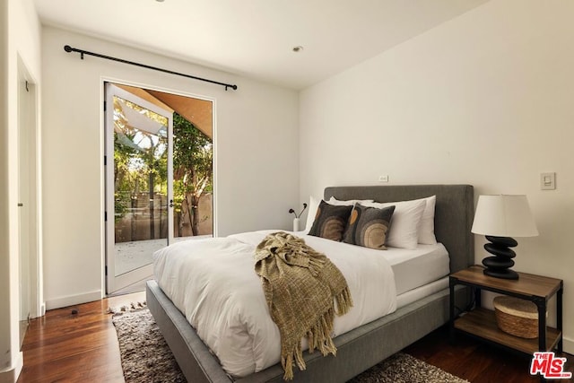 bedroom featuring access to exterior and dark hardwood / wood-style flooring