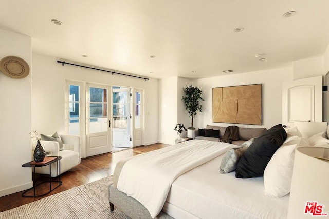 bedroom featuring hardwood / wood-style floors and access to exterior