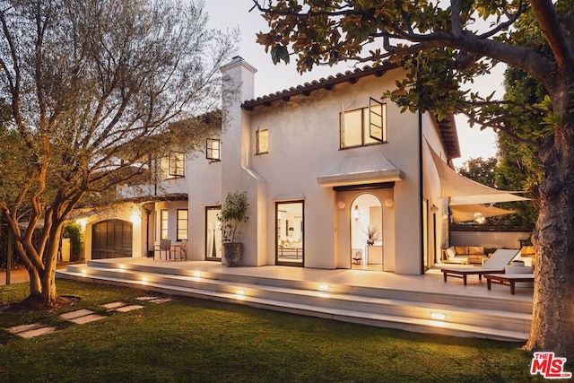 view of front of house with outdoor lounge area and a patio area