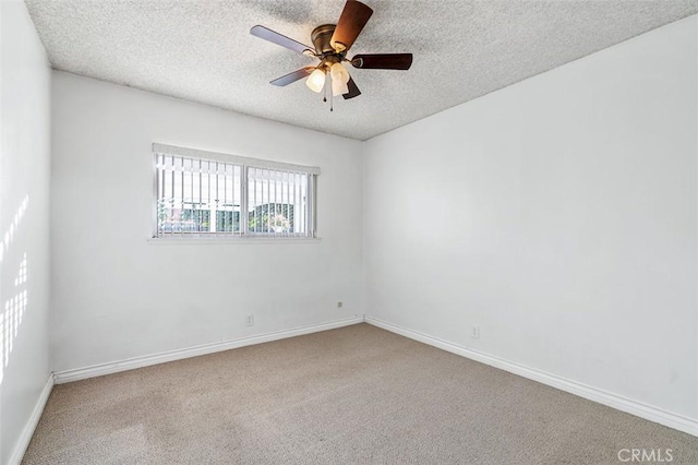 carpeted empty room featuring ceiling fan and a textured ceiling