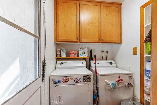 washroom with washing machine and dryer and cabinets