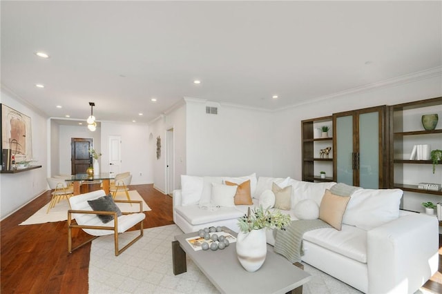 living room featuring light hardwood / wood-style floors and crown molding