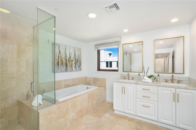 bathroom featuring tile patterned flooring, shower with separate bathtub, and vanity