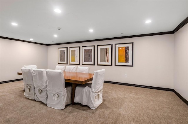 carpeted dining area featuring ornamental molding