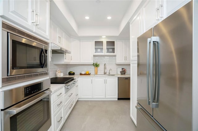 kitchen featuring sink, white cabinets, stainless steel appliances, and light tile patterned floors