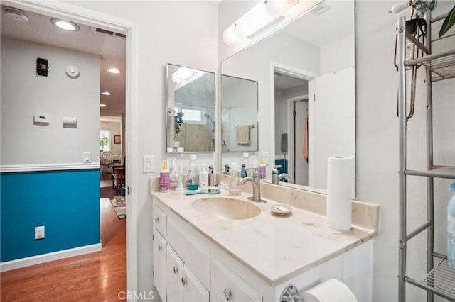 bathroom with hardwood / wood-style flooring and vanity