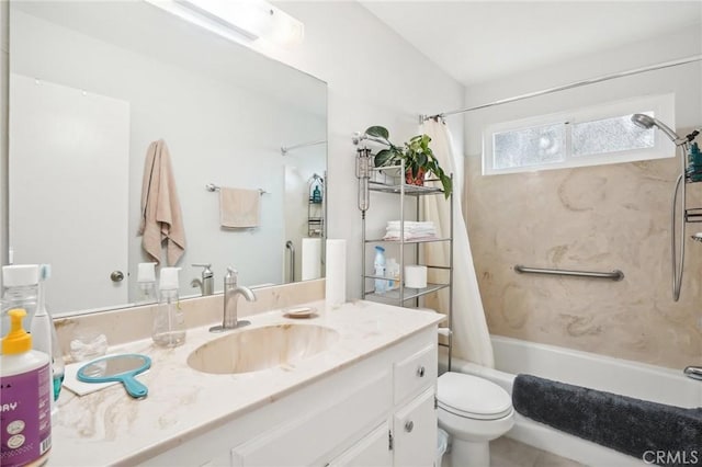 full bathroom with vanity, shower / tub combo, and toilet