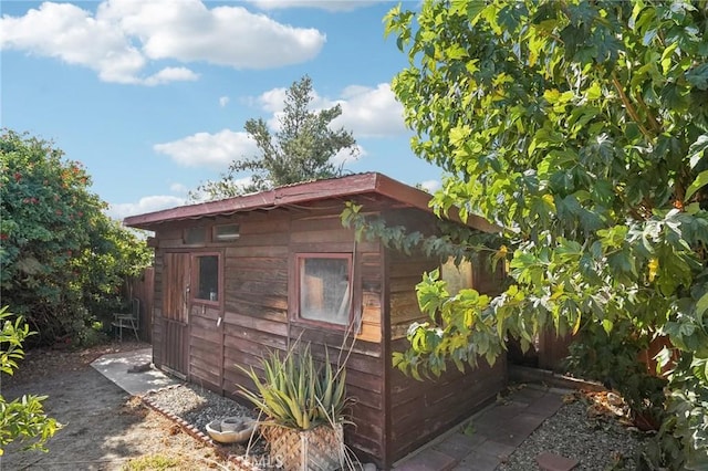 view of side of property with a storage unit